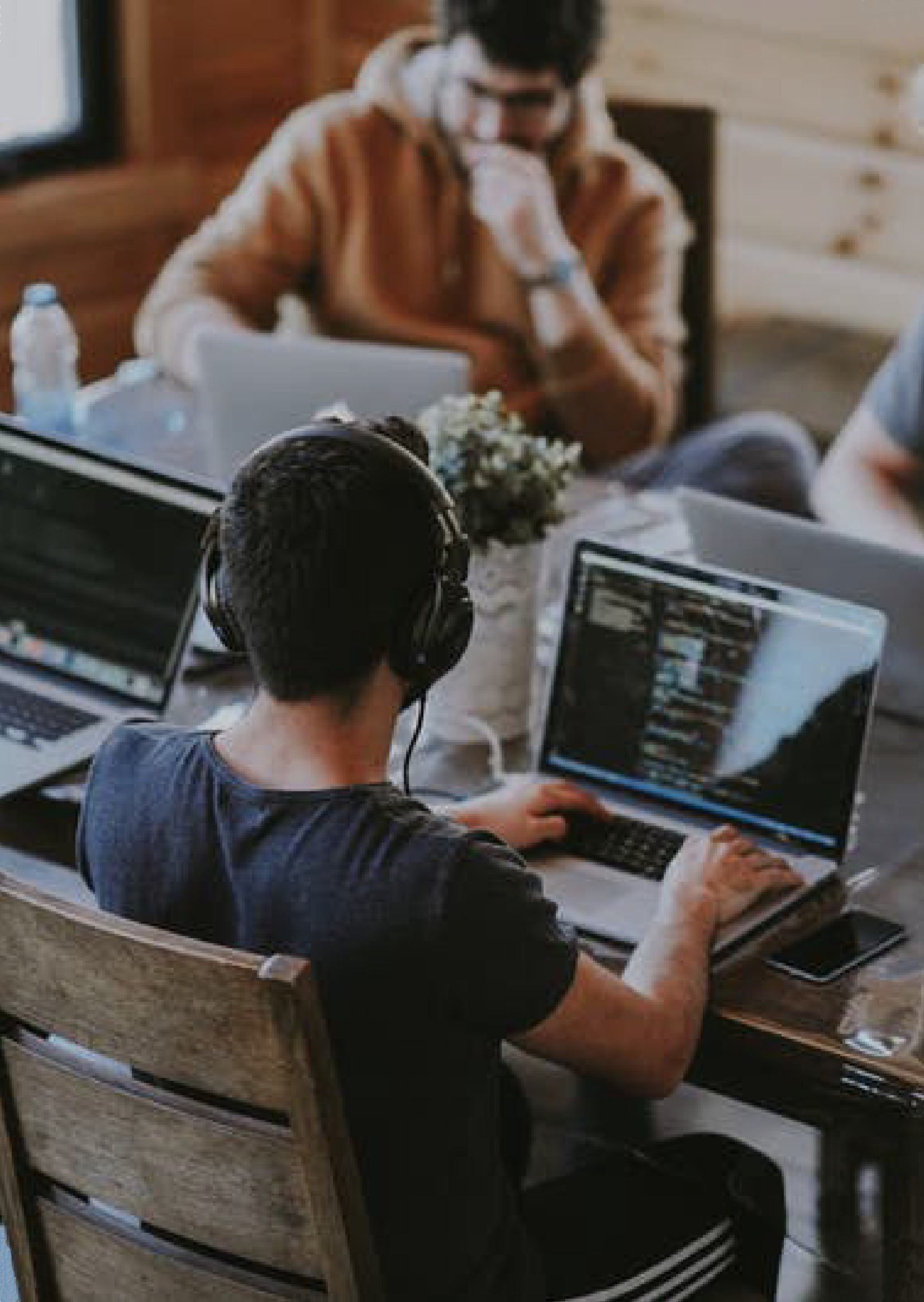 Man working at laptop with headphones on