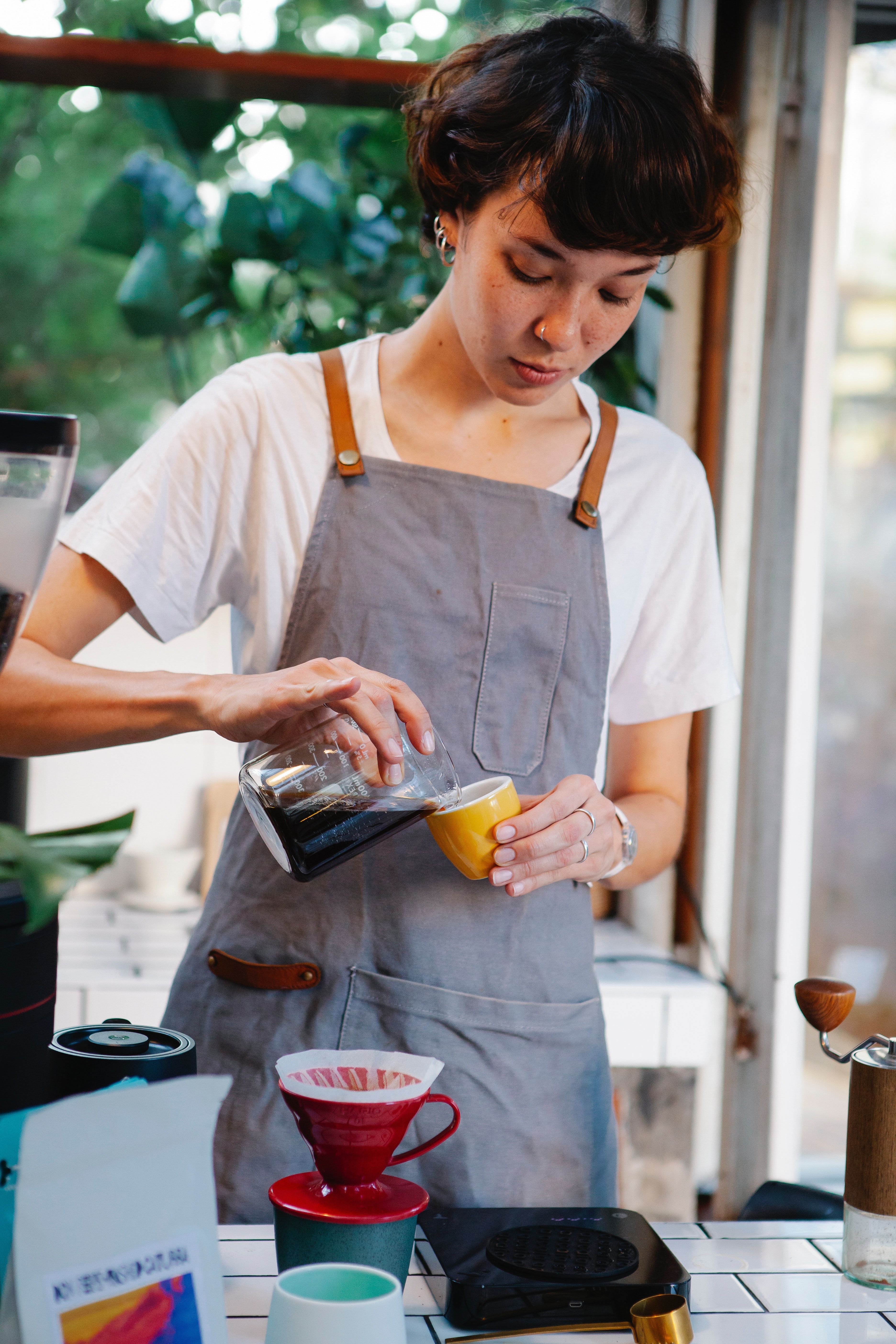 A teenager is pouring coffee in a coffee shop cyber security courses